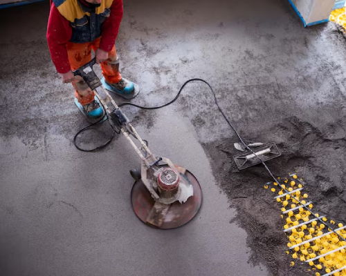 professional applying screed compound to floor